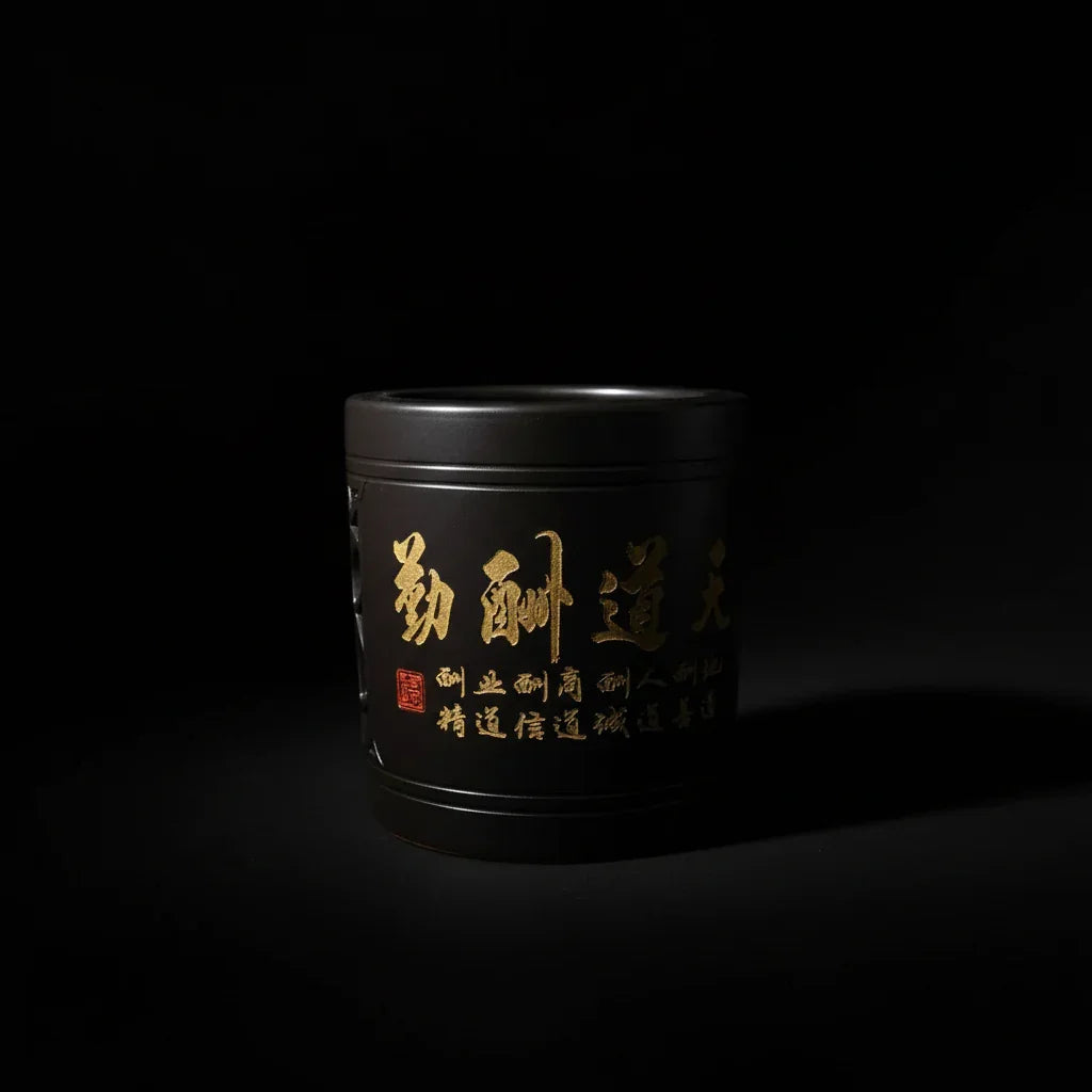 Luxury handcrafted black ceramic vessel with gold calligraphy, artisanal PROSPERA style