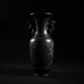 Luxury handcrafted black ceramic vase with intricate detailing, artisan sculptural art